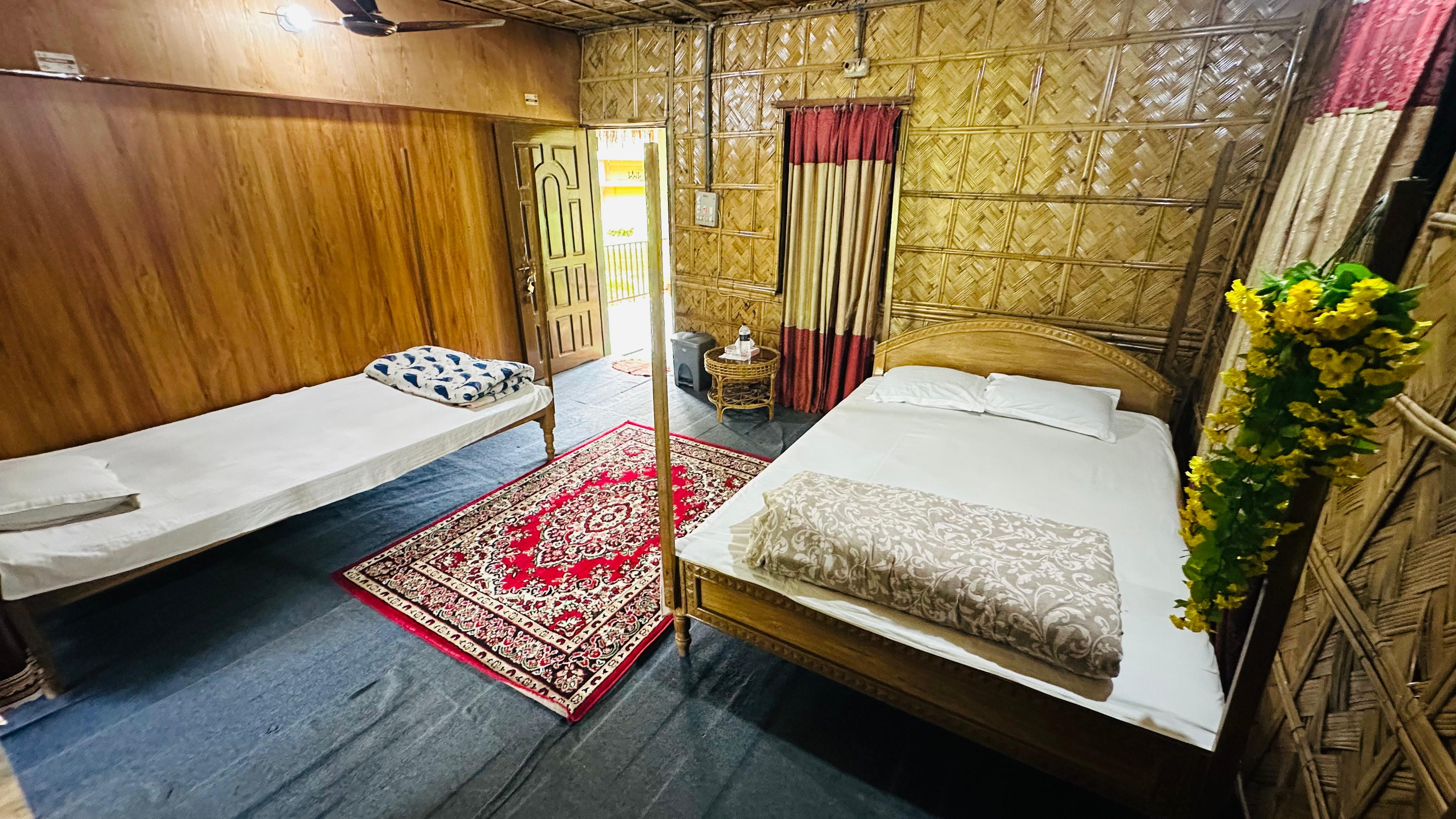 Shokuntola Family Cottage bedroom at Litchibari Eco Resort
